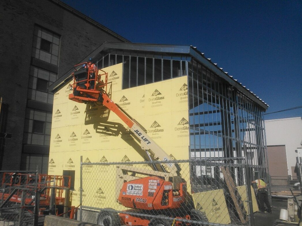 Steel building construction being completed with quality materials